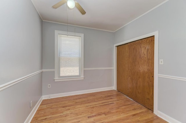 6834 S Rockwell St, Chicago, IL 60629 - unfurnished bedroom with light wood finished floors, crown molding, a closet, a ceiling fan, and baseboards