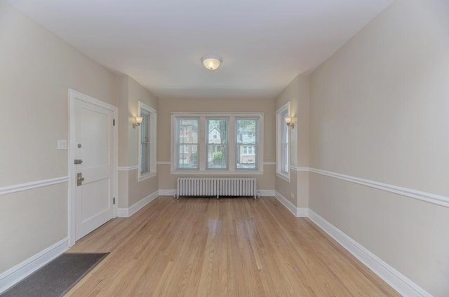 6834 S Rockwell St, Chicago, IL 60629 - entrance foyer featuring radiator, light wood finished floors, and baseboards