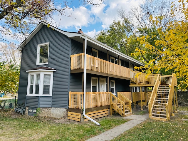 220 S Entrance Ave, Kankakee, IL 60901 - rear view of house featuring stairway, a chimney, a balcony, and covered porch