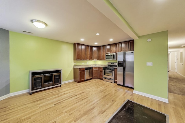 4440 N Dover St Unit Gs, Chicago, IL 60640 - kitchen featuring appliances with stainless steel finishes, light wood-style floors, recessed lighting, and dark brown cabinetry