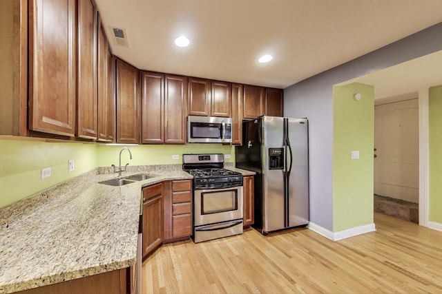 4440 N Dover St Unit Gs, Chicago, IL 60640 - kitchen with stainless steel appliances, light wood-style flooring, light stone counters, and recessed lighting