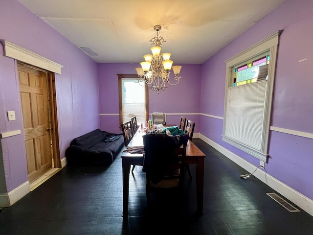 335 N Highway Ave, Deland, IL 61839 - dining area with a chandelier, baseboards, and dark wood-type flooring