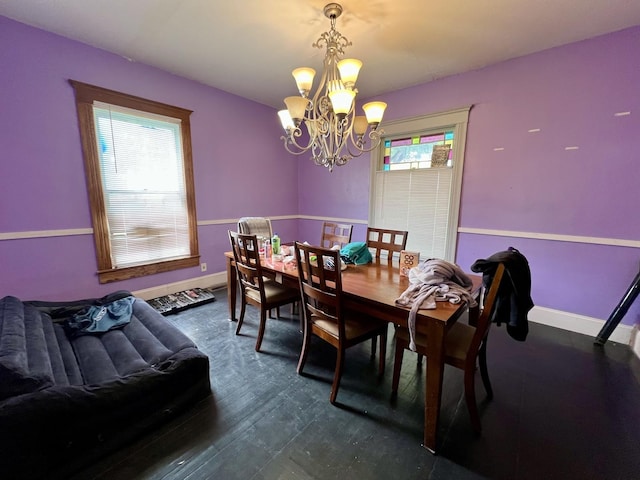 335 N Highway Ave, Deland, IL 61839 - dining area featuring a chandelier, healthy amount of natural light, and baseboards
