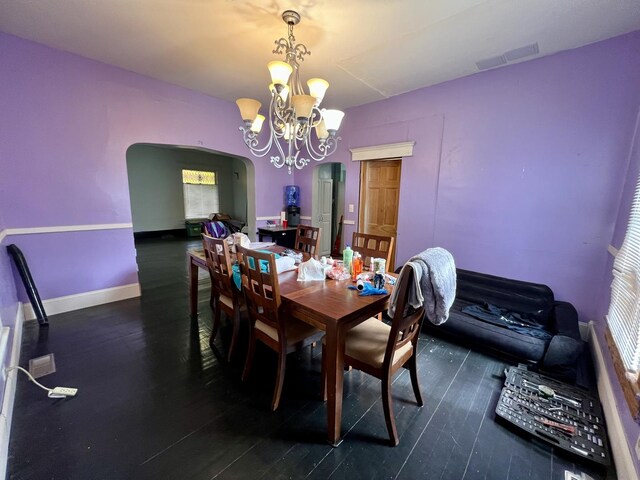 335 N Highway Ave, Deland, IL 61839 - dining room with arched walkways, a chandelier, wood finished floors, and healthy amount of natural light