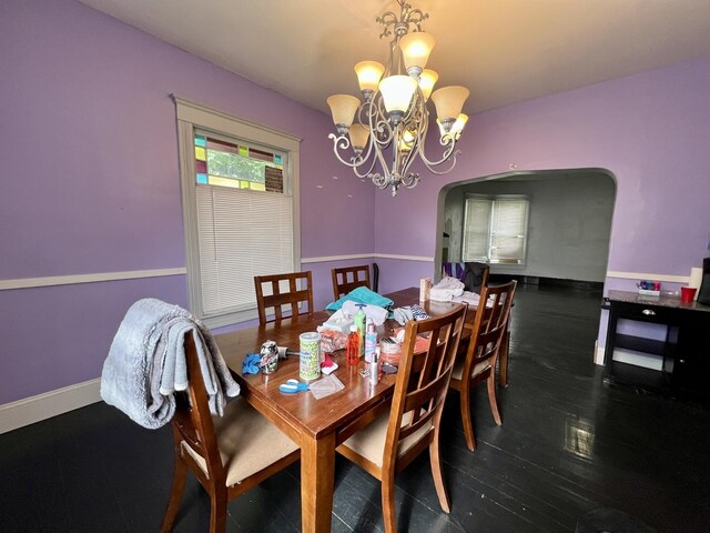 335 N Highway Ave, Deland, IL 61839 - dining space with a chandelier, arched walkways, wood finished floors, and baseboards
