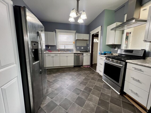 335 N Highway Ave, Deland, IL 61839 - kitchen featuring appliances with stainless steel finishes, a sink, wall chimney exhaust hood, a chandelier, and white cabinetry