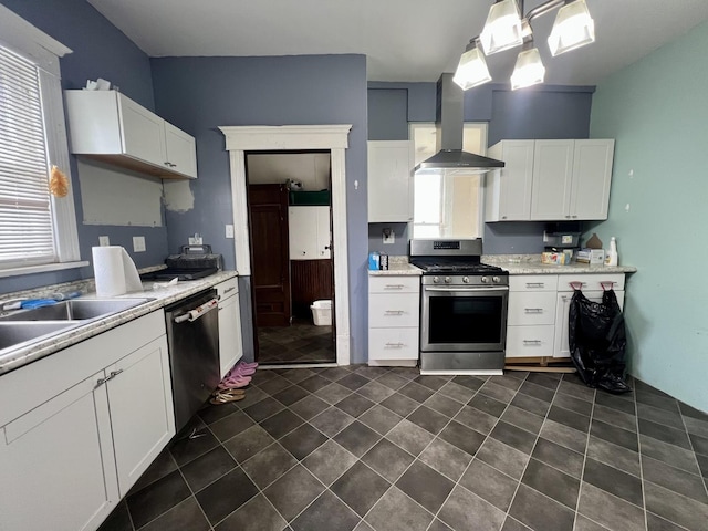 335 N Highway Ave, Deland, IL 61839 - kitchen featuring stainless steel appliances, wall chimney range hood, light countertops, white cabinetry, and a sink