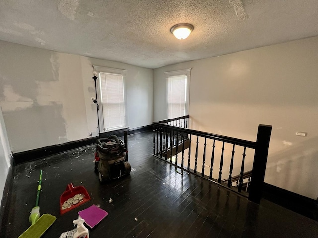 335 N Highway Ave, Deland, IL 61839 - unfurnished room featuring a textured ceiling, baseboards, and wood finished floors