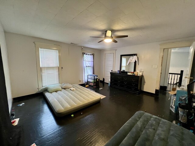 335 N Highway Ave, Deland, IL 61839 - bedroom featuring baseboards, ceiling fan, and wood finished floors