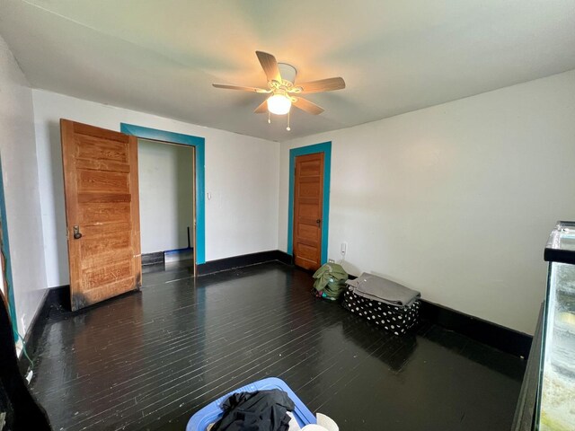 335 N Highway Ave, Deland, IL 61839 - spare room with ceiling fan, wood finished floors, and baseboards