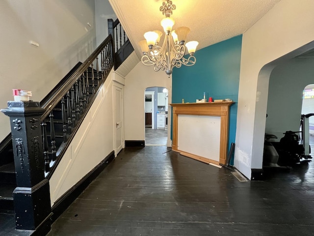 335 N Highway Ave, Deland, IL 61839 - stairway featuring arched walkways, a chandelier, and hardwood / wood-style flooring