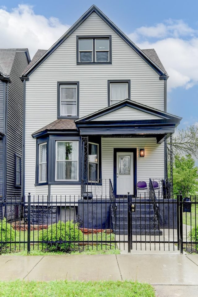 614 E 92nd Pl, Chicago, IL 60619 - american foursquare style home featuring a porch and a fenced front yard