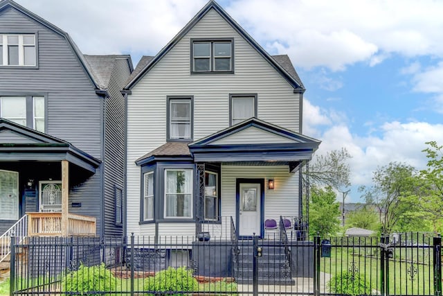 614 E 92nd Pl, Chicago, IL 60619 - view of front of property with covered porch, a fenced front yard, and a shingled roof