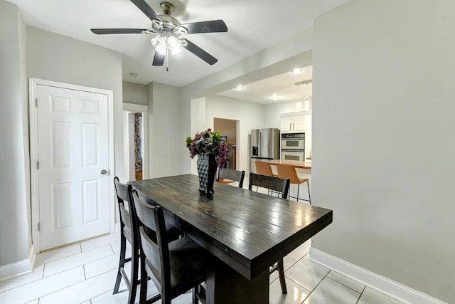 614 E 92nd Pl, Chicago, IL 60619 - dining area with baseboards, a ceiling fan, and light tile patterned floors