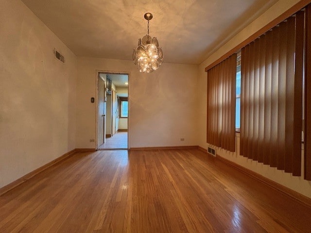8834 S E End Ave, Chicago, IL 60617 - empty room featuring a chandelier, wood finished floors, and baseboards