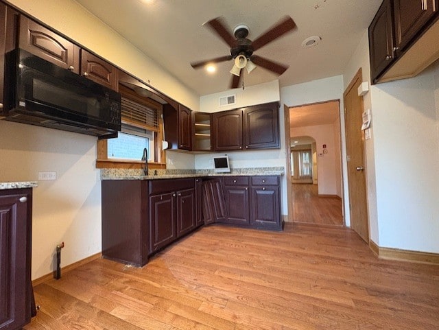 8834 S E End Ave, Chicago, IL 60617 - kitchen featuring black microwave, ceiling fan, dark brown cabinetry, light wood-style flooring, and baseboards