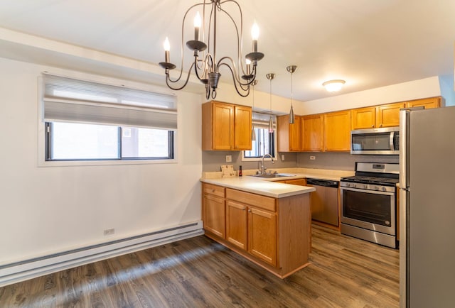 6319 W 64th Pl Unit 1N, Chicago, IL 60638 - kitchen with stainless steel appliances, a sink, baseboard heating, a peninsula, and a chandelier