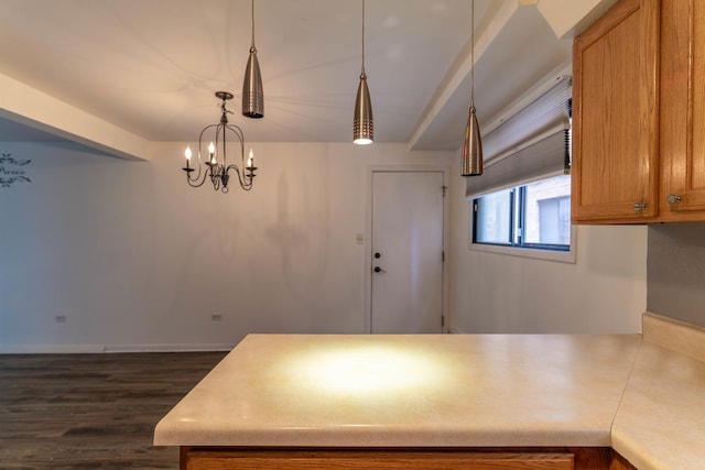 6319 W 64th Pl Unit 1N, Chicago, IL 60638 - kitchen with a peninsula, dark wood finished floors, brown cabinets, and light countertops