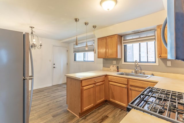 6319 W 64th Pl Unit 1N, Chicago, IL 60638 - kitchen featuring freestanding refrigerator, a sink, range with gas stovetop, a peninsula, and dark wood-style floors