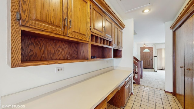 959 S Fern Ave, Elmhurst, IL 60126 - kitchen with light carpet, light countertops, brown cabinetry, light tile patterned flooring, and open shelves
