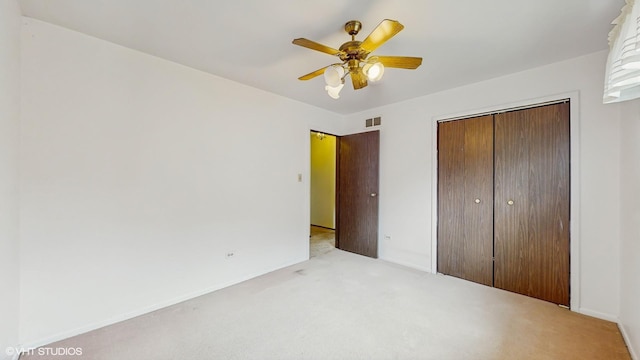 959 S Fern Ave, Elmhurst, IL 60126 - unfurnished bedroom with light carpet, a closet, ceiling fan, and baseboards