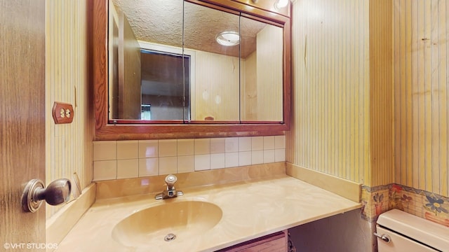 959 S Fern Ave, Elmhurst, IL 60126 - bathroom featuring vanity, toilet, and decorative backsplash