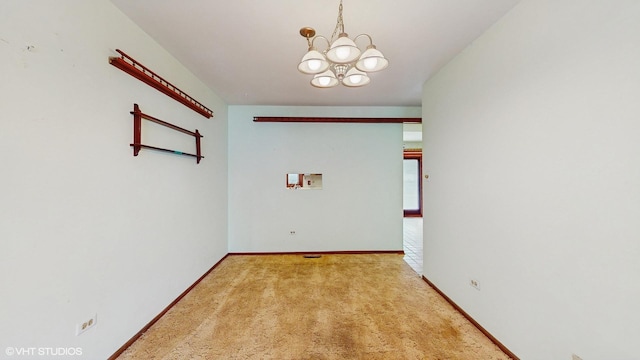 959 S Fern Ave, Elmhurst, IL 60126 - carpeted empty room with a chandelier and baseboards
