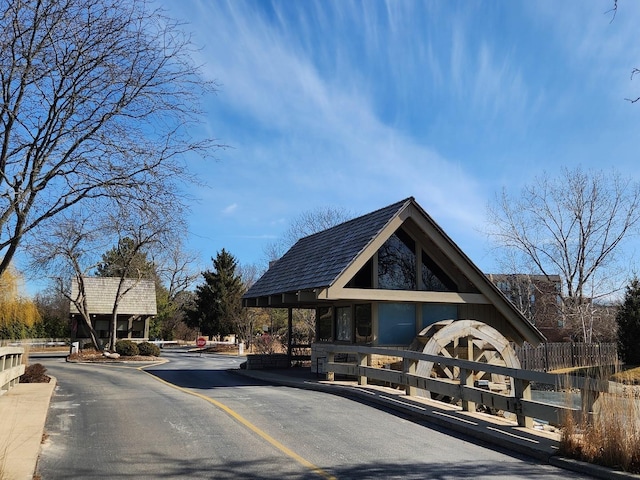 1401 Burr Oak Rd Unit 312B, Hinsdale, IL 60521 - view of asphalt road with curbs, traffic signs, and a gated entry