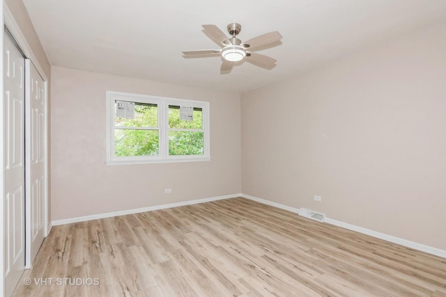 407 Greenfield Rd, Shorewood, IL 60404 - unfurnished bedroom featuring light wood-style floors, baseboards, a closet, and a ceiling fan