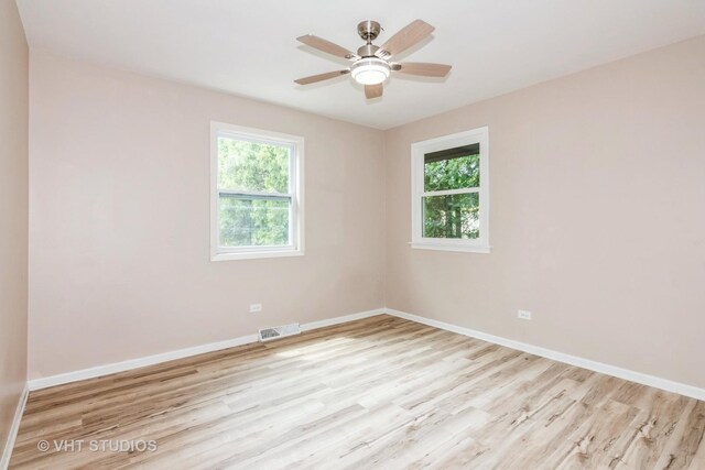 407 Greenfield Rd, Shorewood, IL 60404 - spare room featuring plenty of natural light, wood finished floors, baseboards, and a ceiling fan