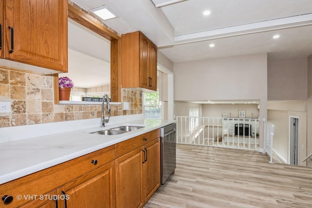 407 Greenfield Rd, Shorewood, IL 60404 - kitchen with a sink, stainless steel dishwasher, tasteful backsplash, light countertops, and brown cabinetry