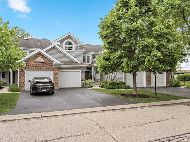1937 N Coldspring Rd, Arlington Heights, IL 60004 - view of front facade featuring brick siding, driveway, and a garage