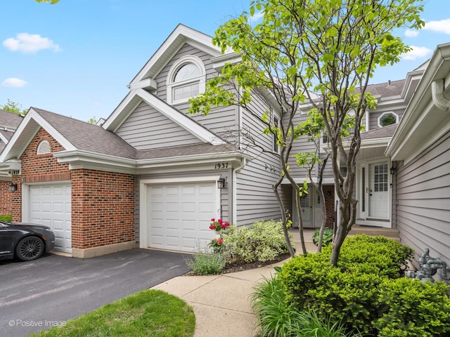 1937 N Coldspring Rd, Arlington Heights, IL 60004 - view of front facade featuring brick siding, roof with shingles, driveway, and an attached garage