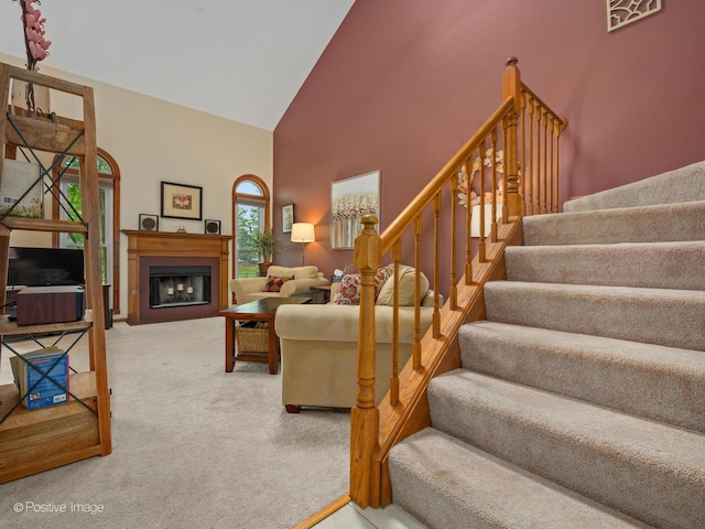 1937 N Coldspring Rd, Arlington Heights, IL 60004 - carpeted living room with high vaulted ceiling, stairs, and a fireplace