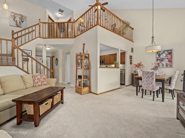 1937 N Coldspring Rd, Arlington Heights, IL 60004 - living room featuring a towering ceiling, stairway, light colored carpet, baseboards, and ceiling fan