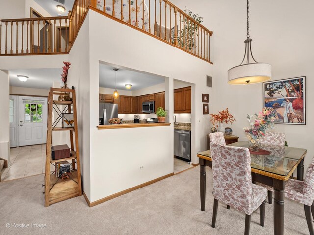 1937 N Coldspring Rd, Arlington Heights, IL 60004 - dining room with a towering ceiling, light colored carpet, and baseboards