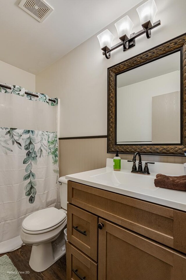 25122 Faraday Rd, Manhattan, IL 60442 - full bathroom featuring toilet, vanity, wainscoting, wood finished floors, and a shower with shower curtain
