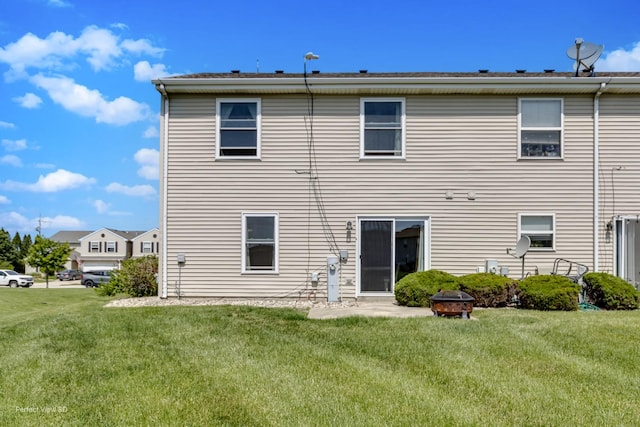 25122 Faraday Rd, Manhattan, IL 60442 - rear view of house with an outdoor fire pit and a lawn