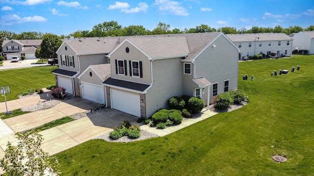 25122 Faraday Rd, Manhattan, IL 60442 - view of front of house with an attached garage, driveway, a shingled roof, and a front yard