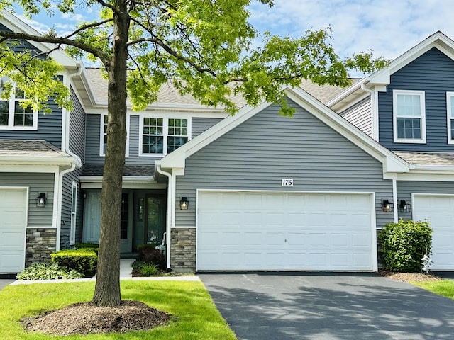 176 Millers Xing, Itasca, IL 60143 - view of front of house featuring driveway, stone siding, an attached garage, and a shingled roof