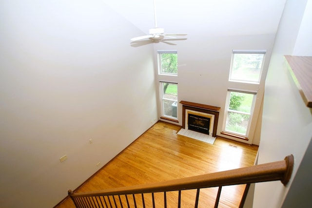 176 Millers Xing, Itasca, IL 60143 - living area with plenty of natural light, light wood-type flooring, ceiling fan, a high ceiling, and a tile fireplace