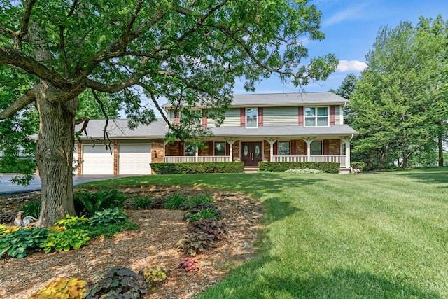 19N050 Felsmith Rd, Hampshire, IL 60140 - view of front of house with covered porch, a front lawn, a garage, driveway, and brick siding