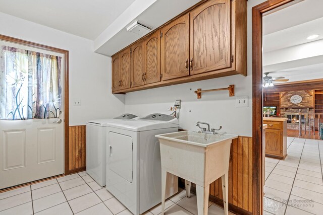 19N050 Felsmith Rd, Hampshire, IL 60140 - laundry room featuring washer and clothes dryer, light tile patterned floors, cabinet space, ceiling fan, and a brick fireplace