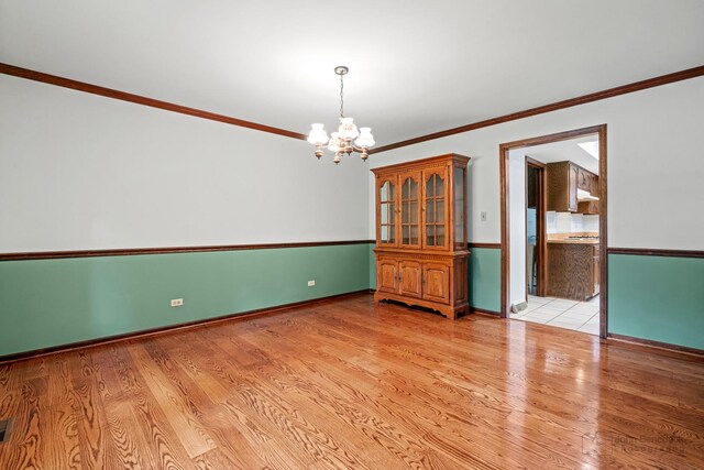 19N050 Felsmith Rd, Hampshire, IL 60140 - unfurnished room with a chandelier, ornamental molding, and light wood-style floors