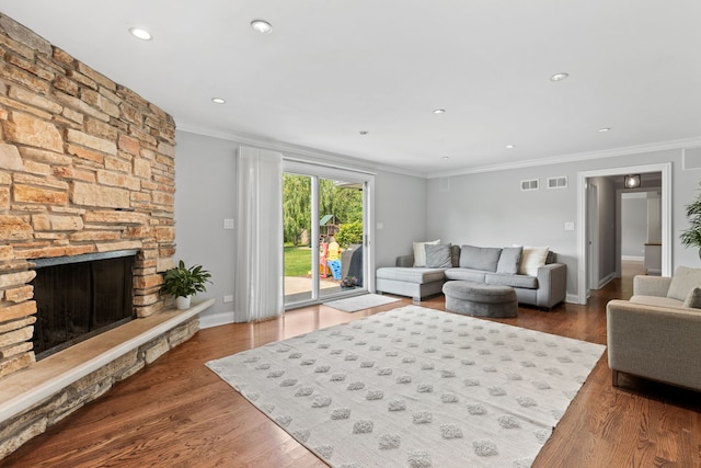 2510 Marian Ln, Wilmette, IL 60091 - living area featuring crown molding, wood finished floors, a stone fireplace, baseboards, and recessed lighting