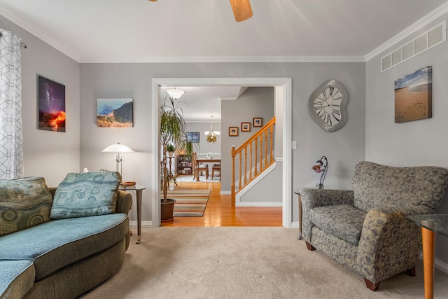 1912 Oak Park Dr, Champaign, IL 61822 - carpeted living room with a chandelier, ornamental molding, stairway, baseboards, and wood finished floors