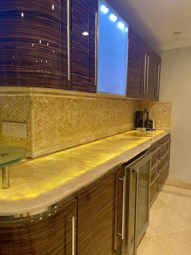 111 E Chestnut St Unit 24C, Chicago, IL 60611 - indoor dry bar featuring wine cooler, crown molding, decorative backsplash, and light tile patterned floors