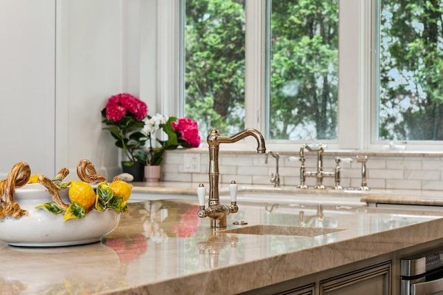 kitchen view of tasteful backsplash and light stone countertops