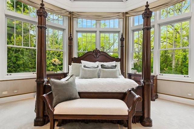 carpeted bedroom with crown molding and wood walls