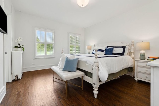 bedroom featuring dark wood-type flooring and baseboards